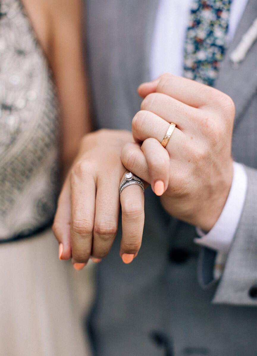 Wedding Ring Design: A bride and groom doing a pink promise with their rings on.