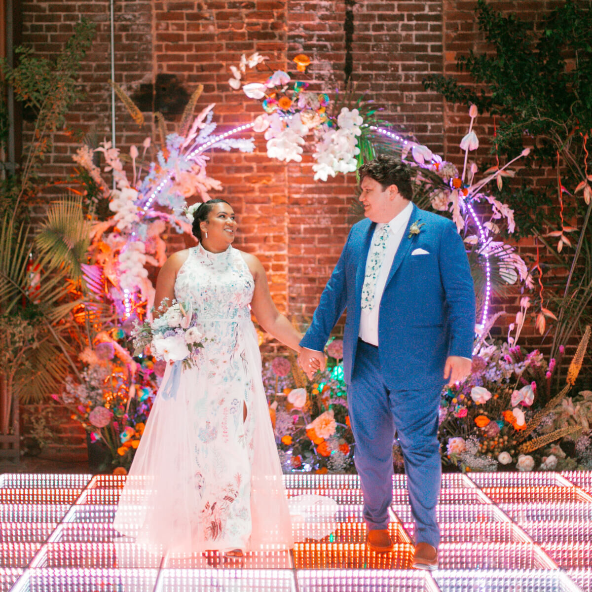 Wedding vendor: wedding couple Courtney and Josh walking while holding hands