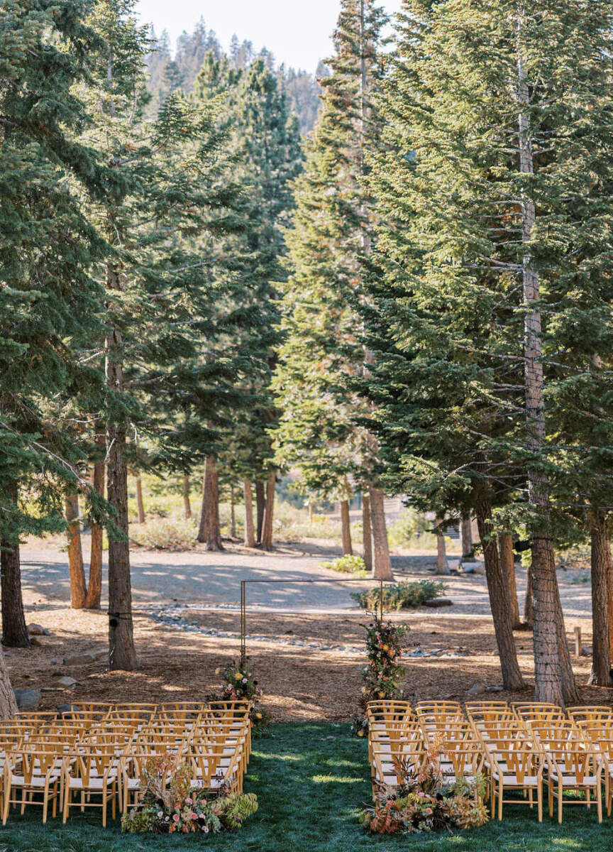 Wedding Venues in California: Tall trees surrounding an outdoor ceremony setup with wooden chairs in Northern California.