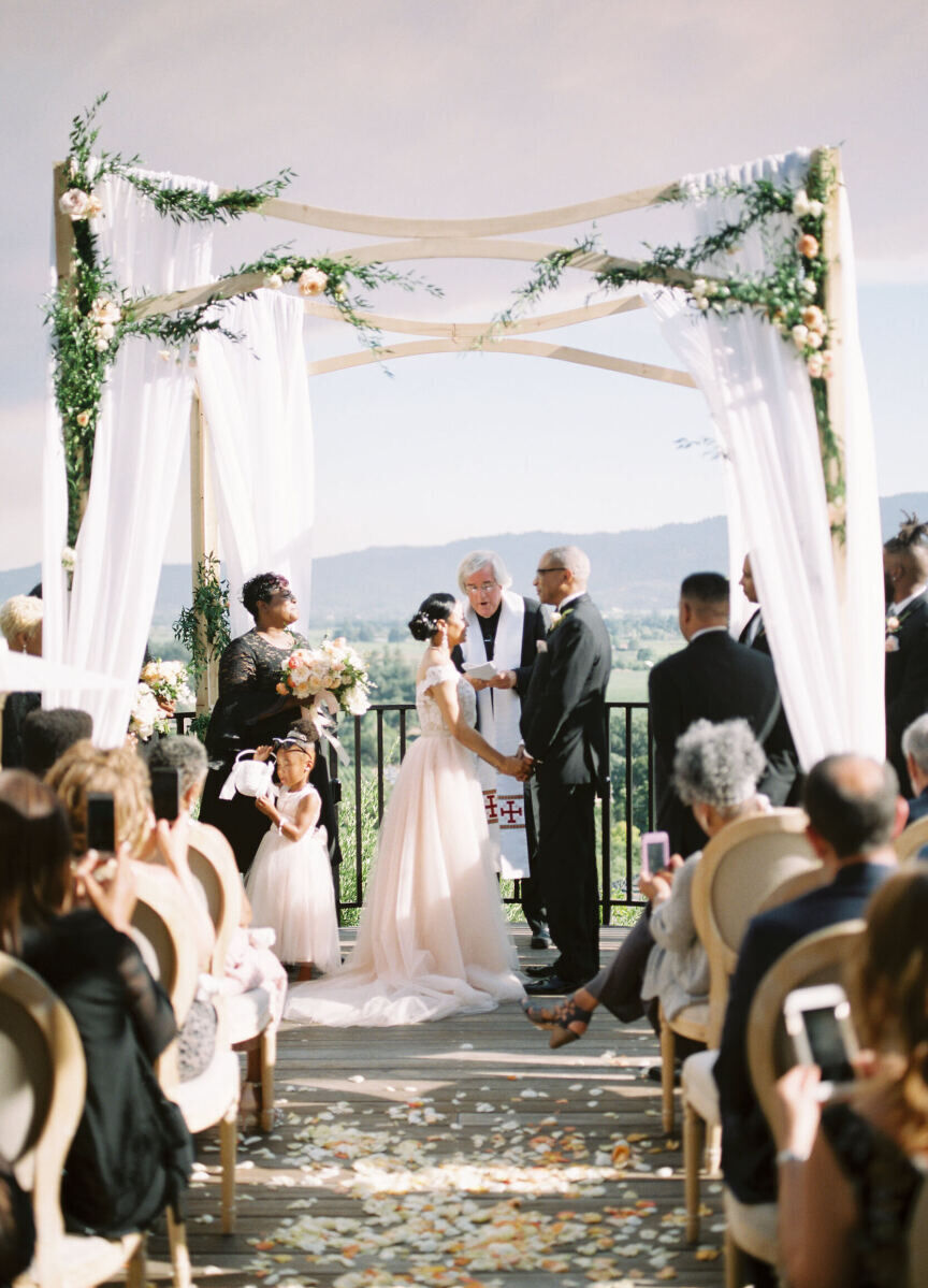 Wedding Venues in California: A couple holding hands under an open gazebo at an outdoor wedding ceremony in Northern California.