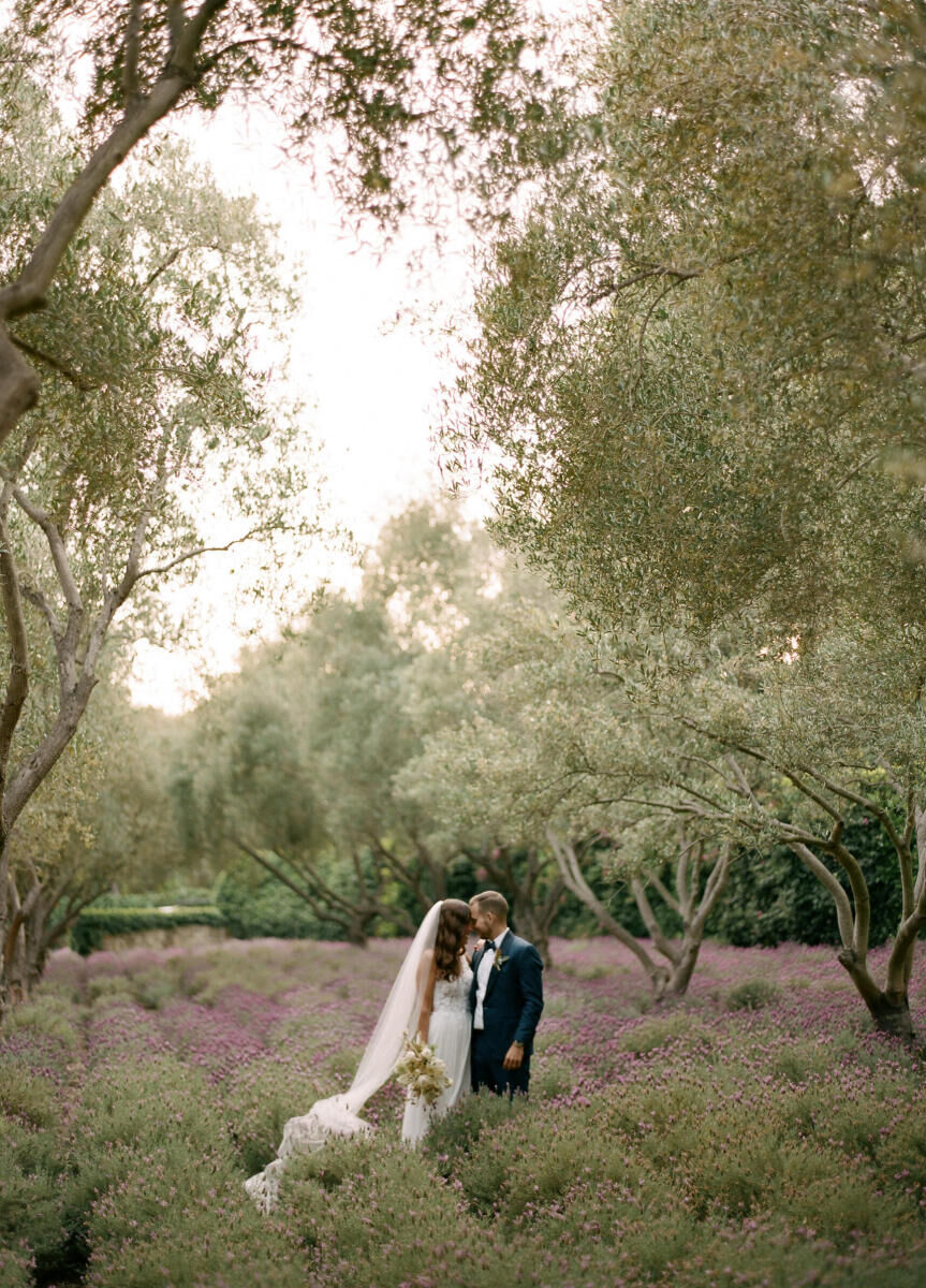 Wedding Venues in California: A couple with their foreheads touching in a garden at a ranch wedding venue.