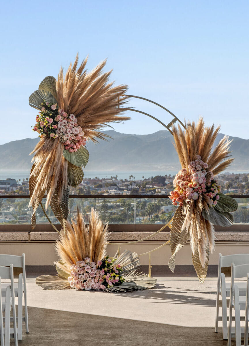 Wedding Venues in California: A boho-inspired arch at a ceremony setup on a rooftop overlooking Marina del Rey, California.