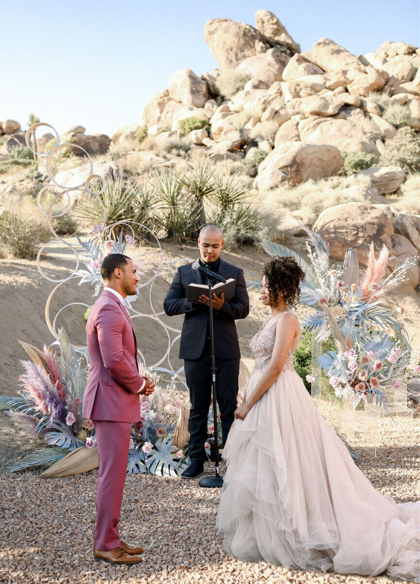 Wedding Venues in California: A wedding couple and their officiant at a ceremony in the middle of Joshua Tree National Park.