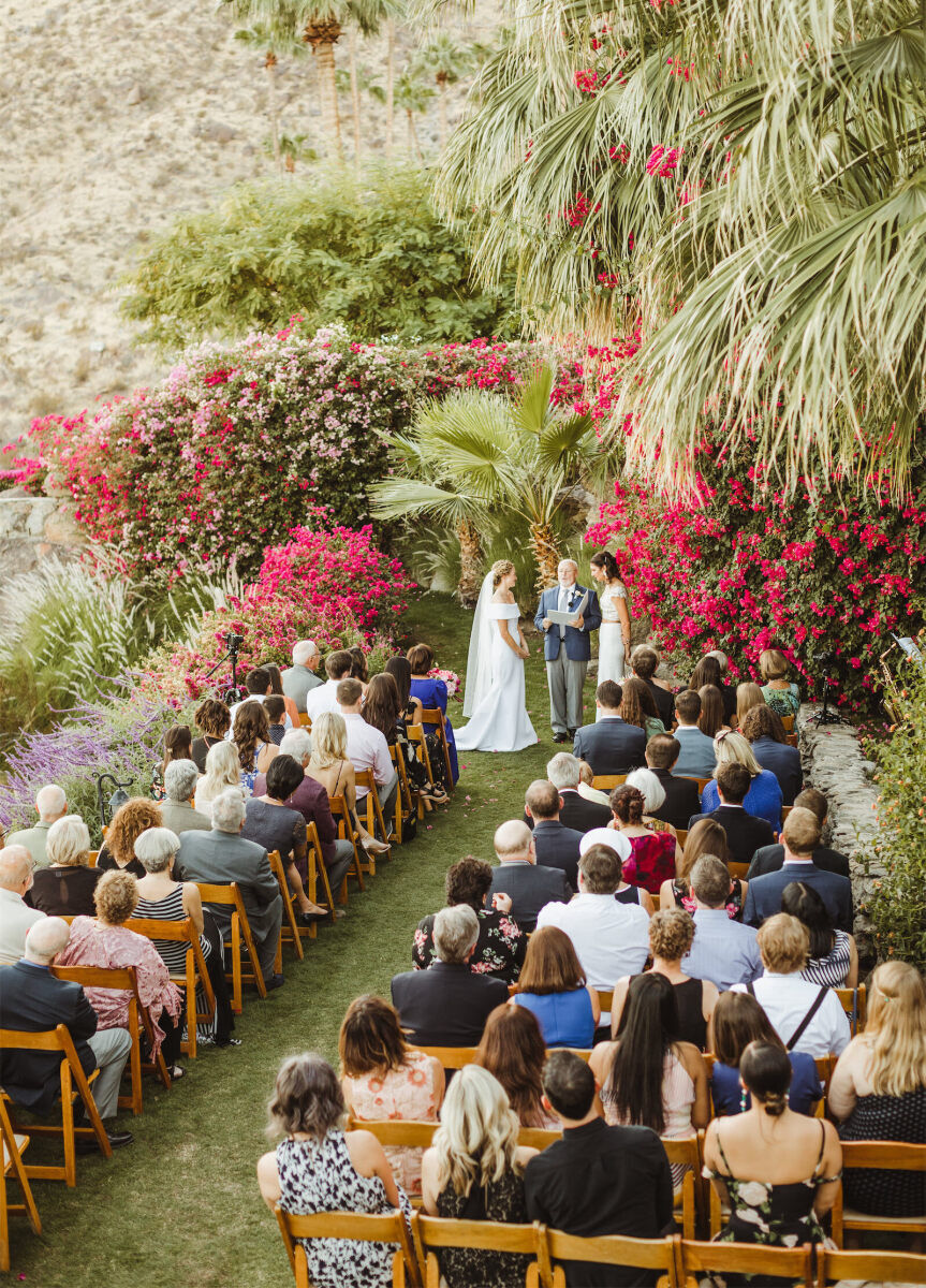 Wedding Venues in California: Two brides exchanging vows at an outdoor ceremony at an estate in the California desert.