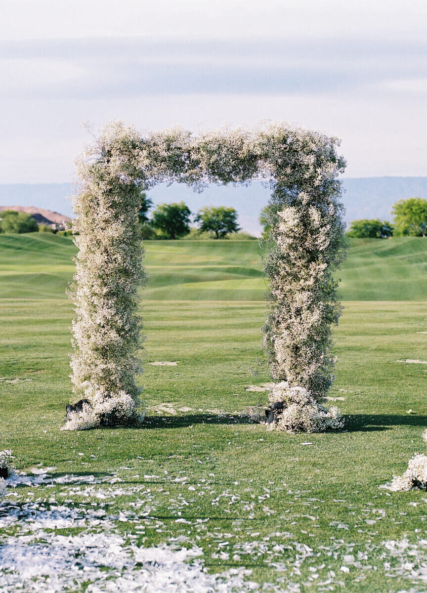 Wedding Venues in California: A floral arch positioned on a golf course in Palm Desert, California.