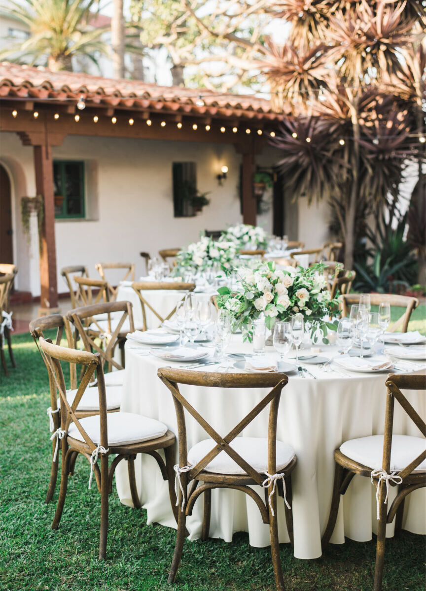 Wedding Venues in California: An outdoor reception setup with a Spanish-style building in the background.