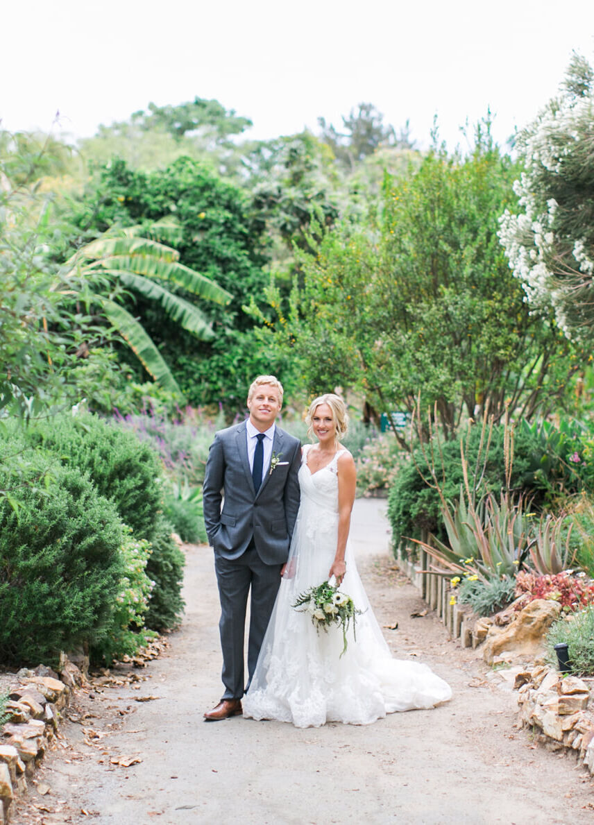 Wedding Venues in California: A bride and groom smiling for a portrait at their botanical garden wedding.