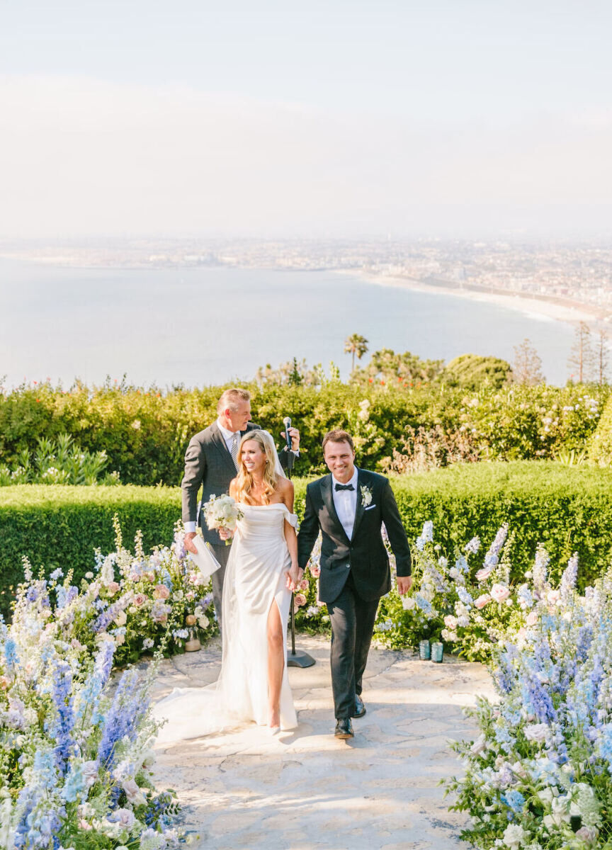 Wedding Venues in California: A wedding couple smiling at the end of their ceremony overlooking Los Angeles and the Pacific Ocean.