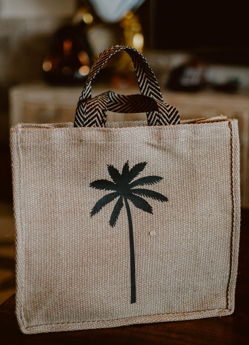 A palm tree logo was printed on welcome bags for a Cabo wedding weekend.