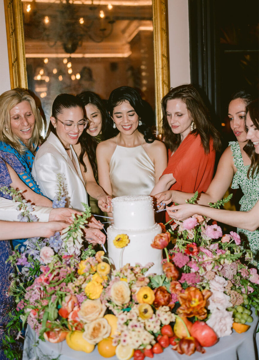 The couple's inner circle grabbed the cake pulls, which had meaningful charms at the ends, a Southern tradition woven into this whimsical wedding.