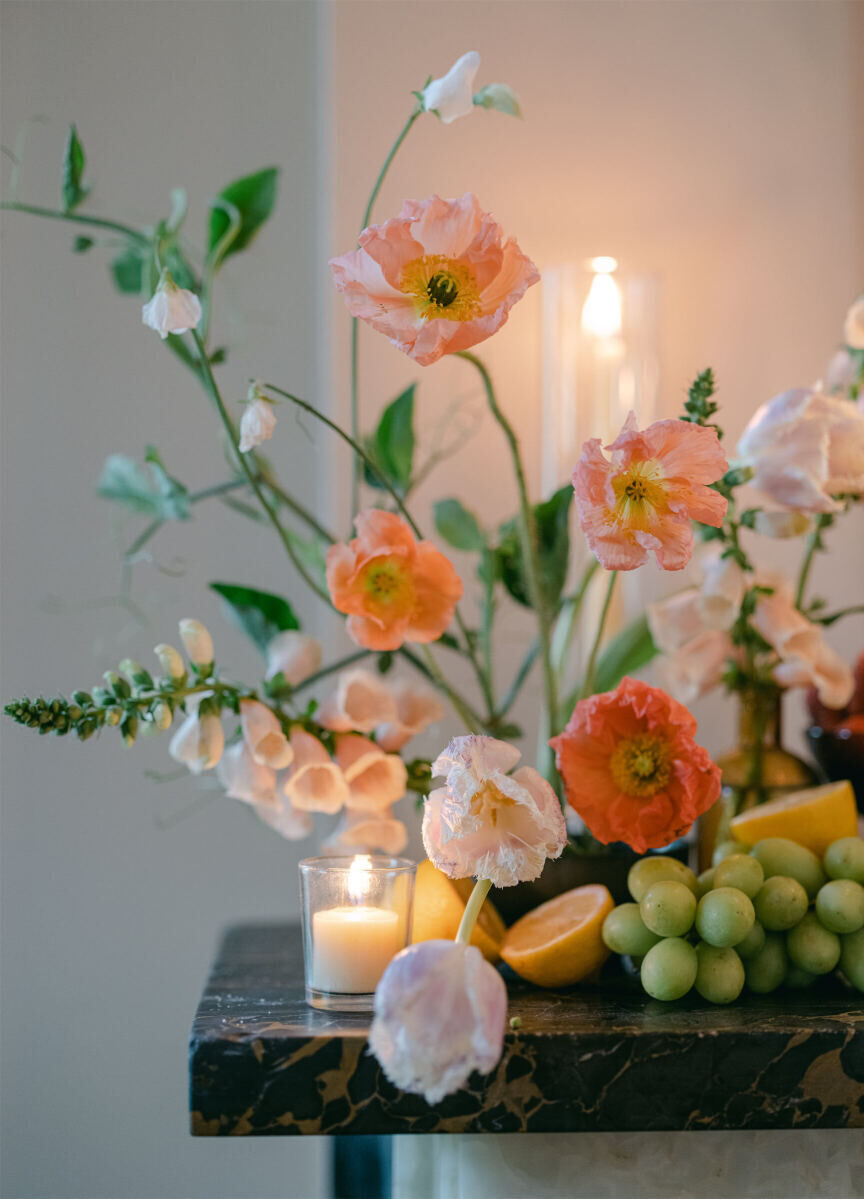 Ikebana-style arrangements of flowers and fruit adorned the reception space of a whimsical wedding in New Orleans.