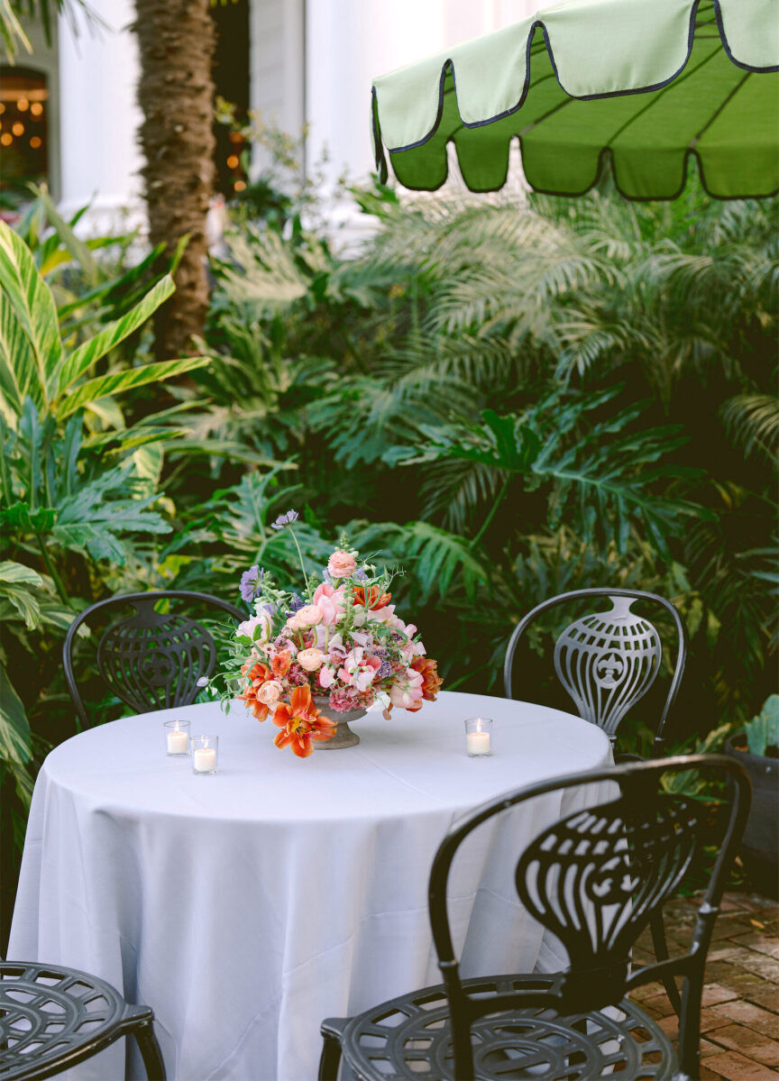 Pale linens dressed the outdoor cocktail tables at this whimsical wedding.