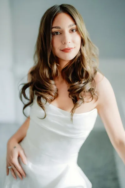 Bridal portrait of a bride in strapless gown featuring a graceful cowl neckline, posed with calm, minimalist elegance.