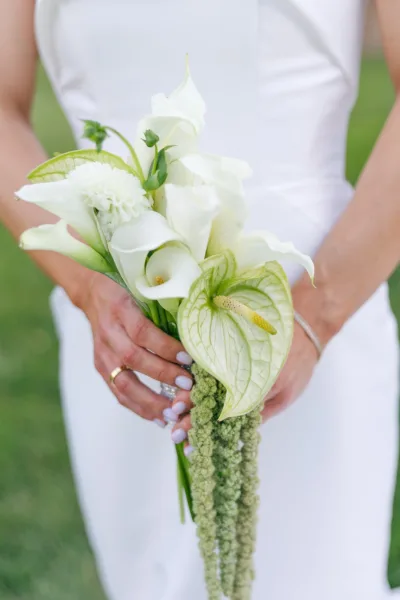 Bridal bouquet, a calla lily wedding bouquet in ivory and green with a clean, modern, structured shape and subtle texture in a compact clutch.