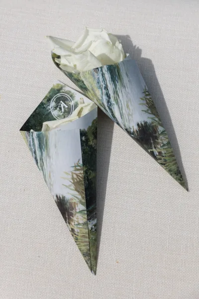 Wedding confetti cones filled with rose petal confetti, wrapped in watercolor print paper for the ceremony exit toss.