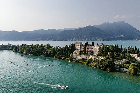 Wedding venue landscape with a lakefront wedding venue, historic villa and manicured gardens beside a shoreline terrace with mountains beyond