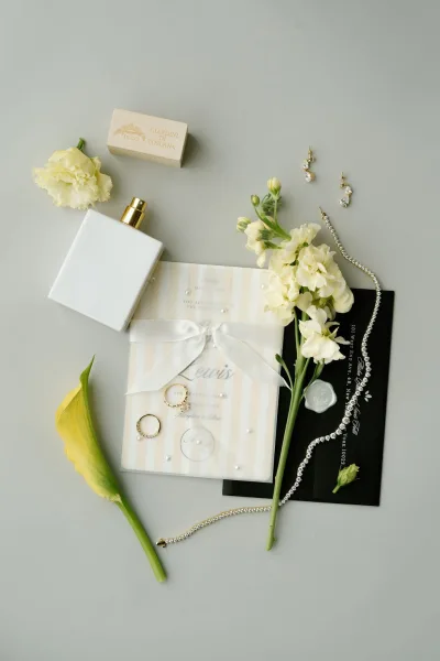 Wedding invitation suite arranged in a neutral flat lay, highlighted by a classic wax seal and clean typography for an elegant feel.