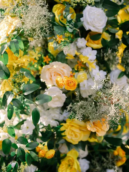 Wedding flowers with a yellow rose arrangement styled in soft, layered blooms for a lush, organic look, inviting and romantic in tone.