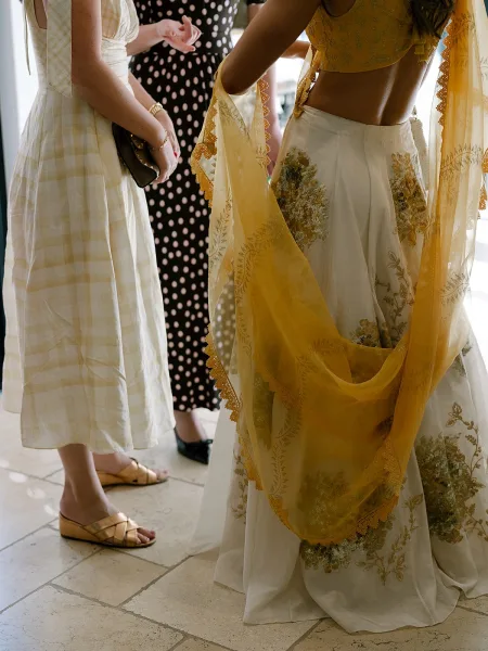 Wedding guest outfits featuring an Indian wedding guest outfit, detailed with floral embroidery, alongside contemporary dresses.