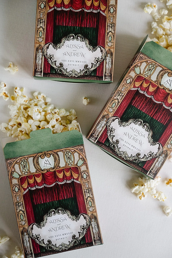 Wedding invitations with illustrated wedding invitation cards, envelopes, and popcorn accents arranged in a flat lay on a white surface