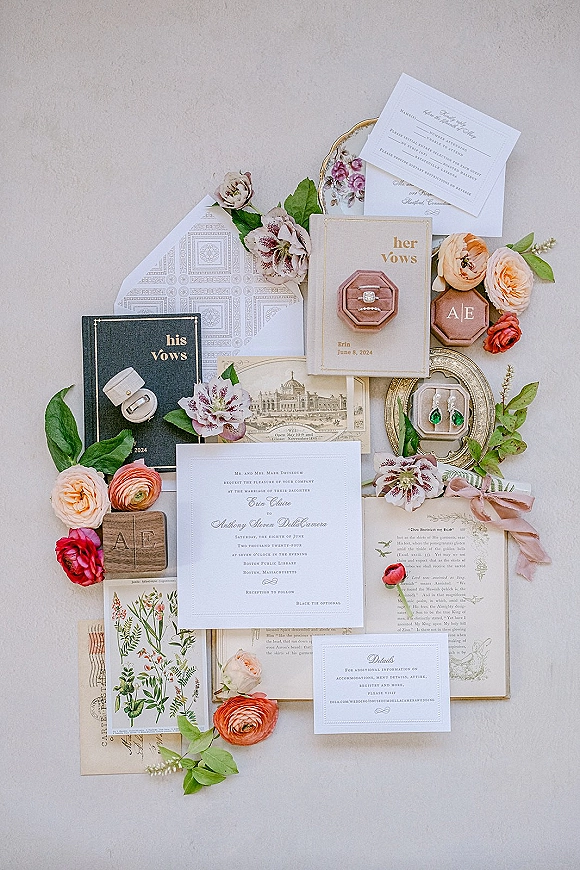 Invitation suite wedding invitation flat lay on linen fabric with RSVP and details cards, ribbon, wax seal, ring box, earrings, florals