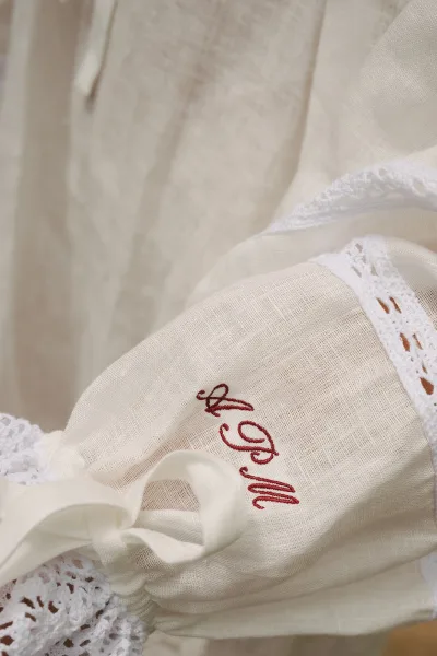Wedding handkerchief with bridal monogram detail in red thread, edged with delicate lace trim for a classic, personalized keepsake look.