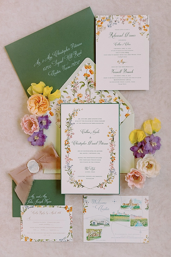 Wedding invitation suite with botanical wedding invitations, sage green envelopes, wax seal and silk ribbon on a neutral fabric backdrop