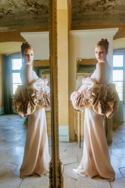 Bridal portrait with mirror bridal portrait feel, bride in a strapless gown with oversized sleeves by large windows in a rustic room