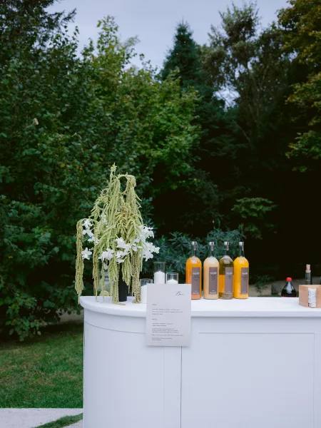 Wedding bar setup designed as an outdoor wedding bar with a sleek counter and a prominent bar menu for guests.