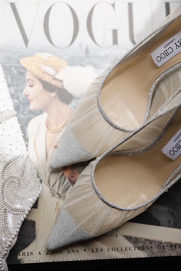 Wedding shoes in sparkly wedding heels, silver glitter pointed-toe pumps on a fashion magazine cover with a visible label tag