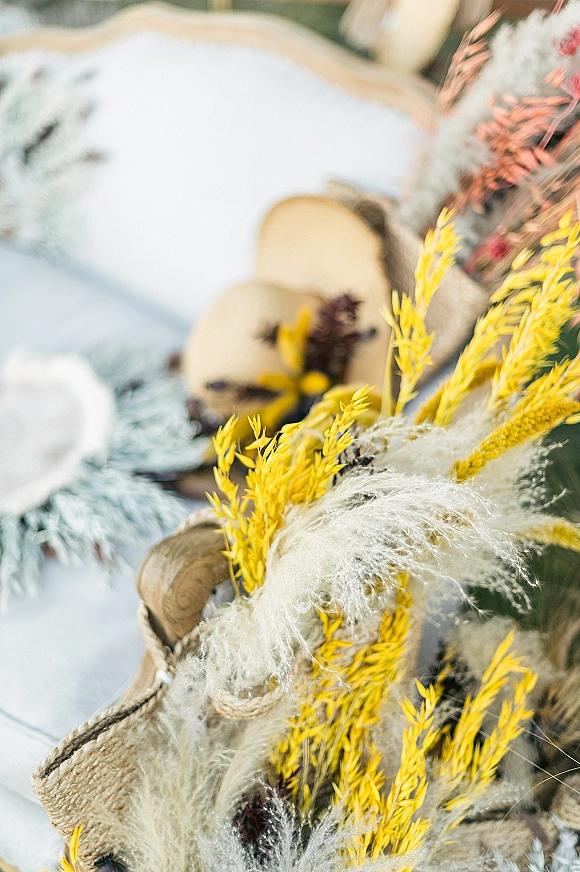 Wedding invitation suite styled with rustic invitation suite details, dried florals and pampas grass on white linens over a wood surface