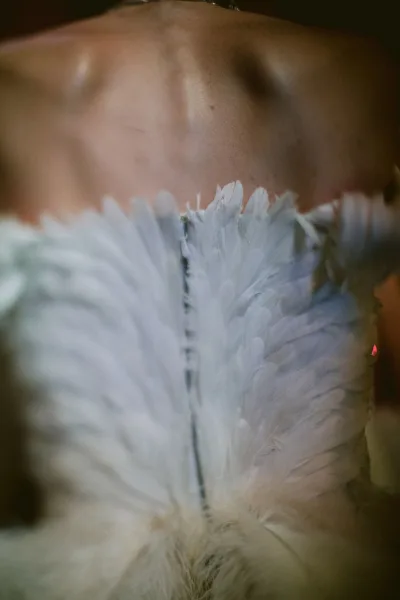 Wedding dress detail of a feather wedding dress highlighting a sleek strapless neckline and subtle texture for a modern, couture bridal look.
