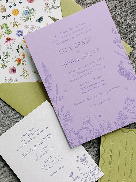 Wedding invitations flatlay featuring a lavender wedding invitation with botanical liner, RSVP and reception cards on gray fur fabric