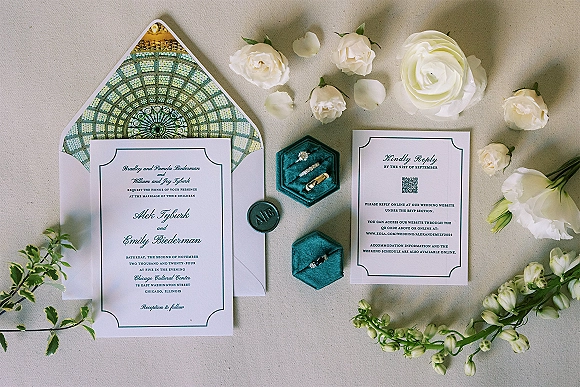 Invitation suite wedding invitation flat lay with wax seal, velvet ring box and rings, white roses and greenery on linen backdrop