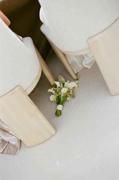 Bouquet close-up of a bridal bouquet, a white calla lily bouquet tightly framed to highlight smooth petals and elegant, sculptural curves.