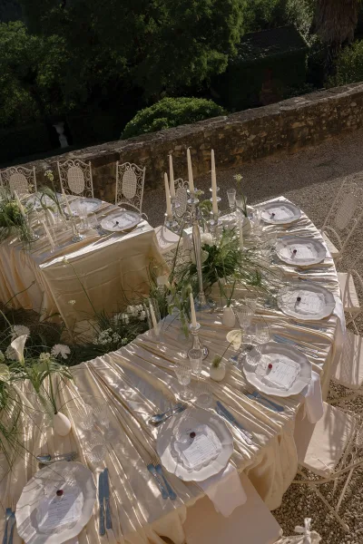 Ivory satin dresses the reception tablescape, where calla lilies form a centerpiece between place settings