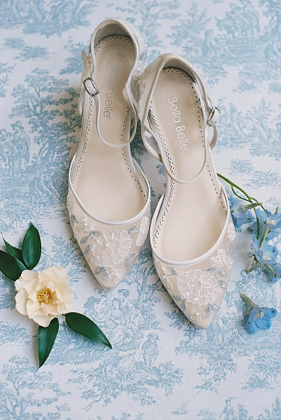Bridal shoes wedding flats with embroidered mesh, ankle strap buckles, and floral appliqué on blue toile fabric with blue flowers and leaves
