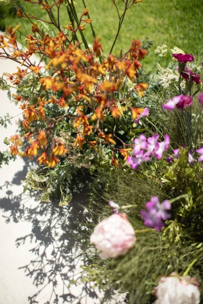 Floral arrangement of outdoor wedding flowers in a meadow-style design, a lush sweep of wildflowers arranged with soft movement and natural texture