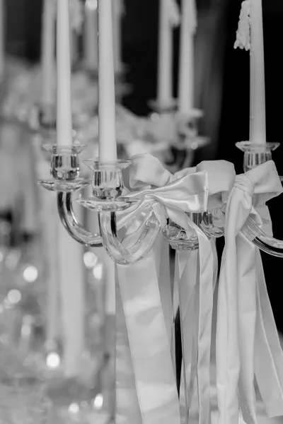 Candelabra centerpiece styled as a taper candle centerpiece, finished with a single bow accent for an elegant, romantic wedding detail.