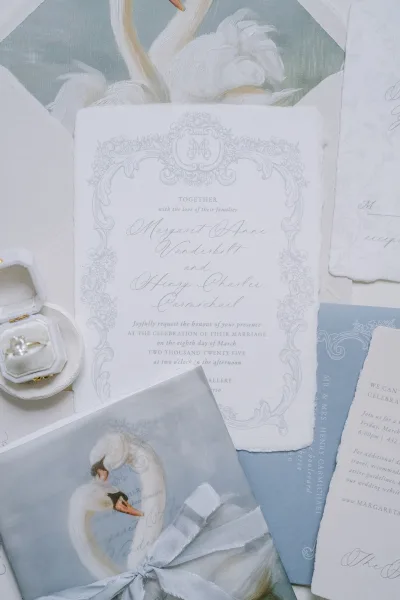 Wedding invitation suite showcasing swan wedding invitations with delicate deckled edges arranged neatly for a refined, romantic feel.