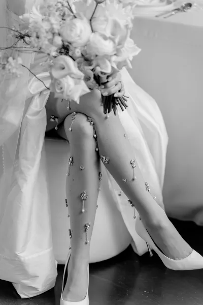 Bridal tights, pearl wedding tights hugging the legs, shimmer softly with high heels, an elegant detail that draws attention to the bride's stride.