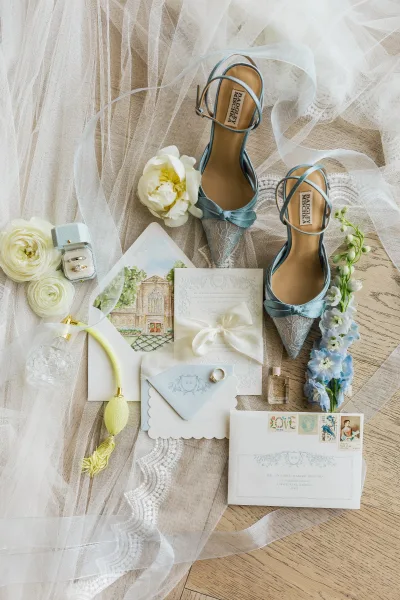 Wedding flat lay with blue bridal shoes, elegant pointed-toe heels styled as the something blue for the day, captured in a refined detail scene.