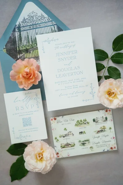 Wedding invitation suite featuring dusty blue wedding invitations and a matching envelope liner, styled in a clean, coordinated flat lay.
