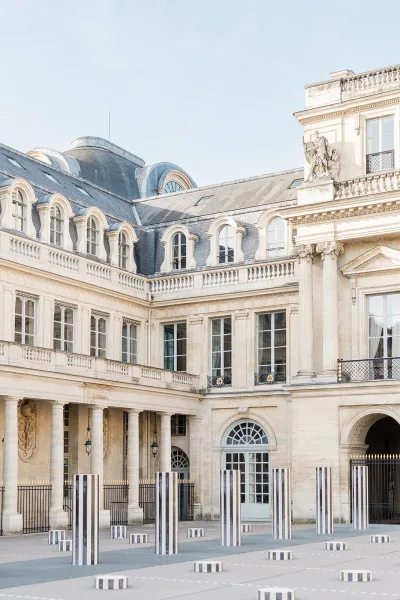 Wedding venue exterior at a historic courtyard venue, defined by striking striped columns flanking the entrance.