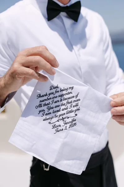 Father of the bride handkerchief, a heartfelt father of the bride gift, with delicate embroidery against blue sky and water.