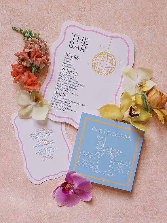 Wedding bar menu and wedding cocktail menu card with pink border and gold disco ball illustration on a blush fabric backdrop
