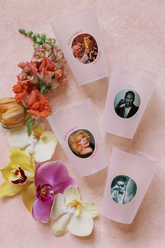 Wedding drink cups with personalized wedding cups decals and photo stickers, frosted plastic finish, styled with orchids on pink textured fabric backdrop