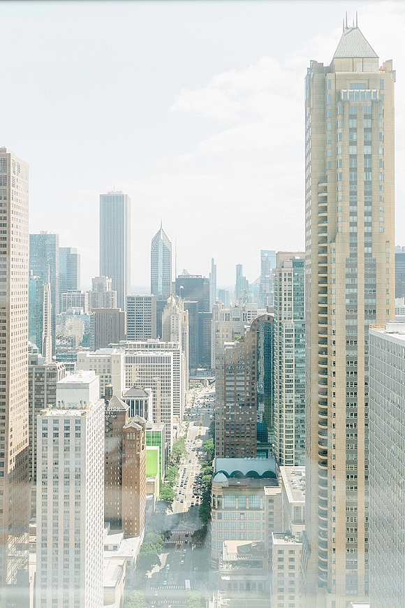 City skyline and downtown skyline view with high rise buildings fading into summer haze above busy streets and cars below