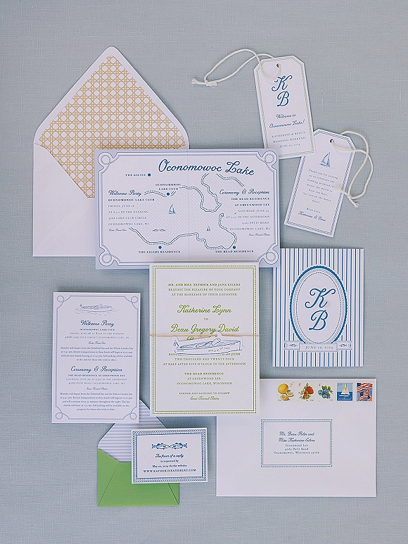 Invitation suite wedding invitation suite flatlay with blue-and-white cards, map illustration, twine tags, and vintage stamps on gray fabric backdrop