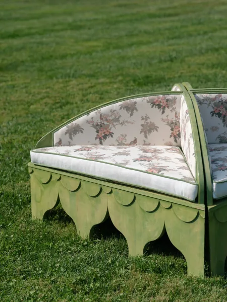 Wedding lounge seating for an outdoor reception lounge, featuring a cozy settee with scalloped trim inviting guests to relax.